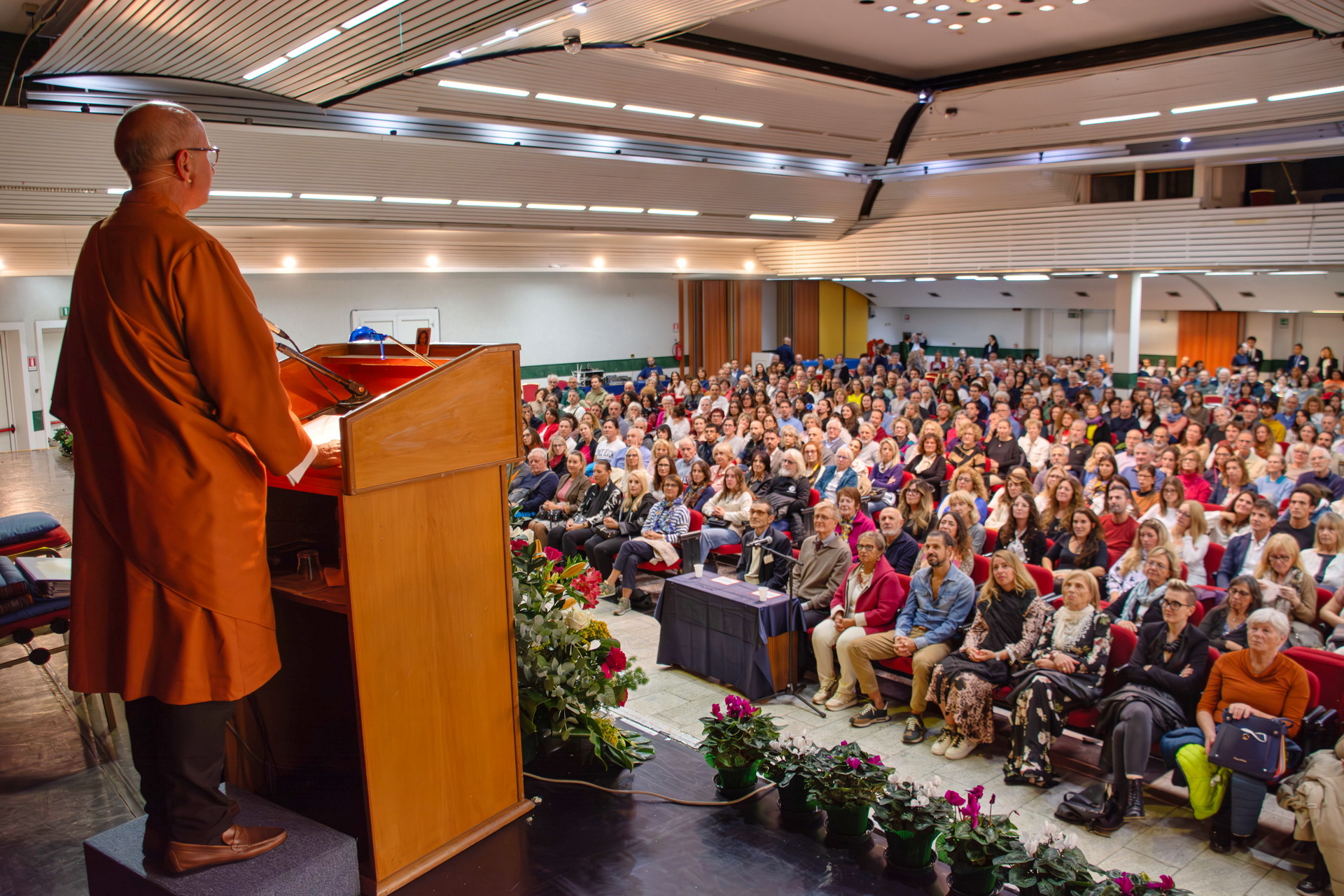 Brother Vidyananda gives a public lecture to an attentive audience in Abano Terme.