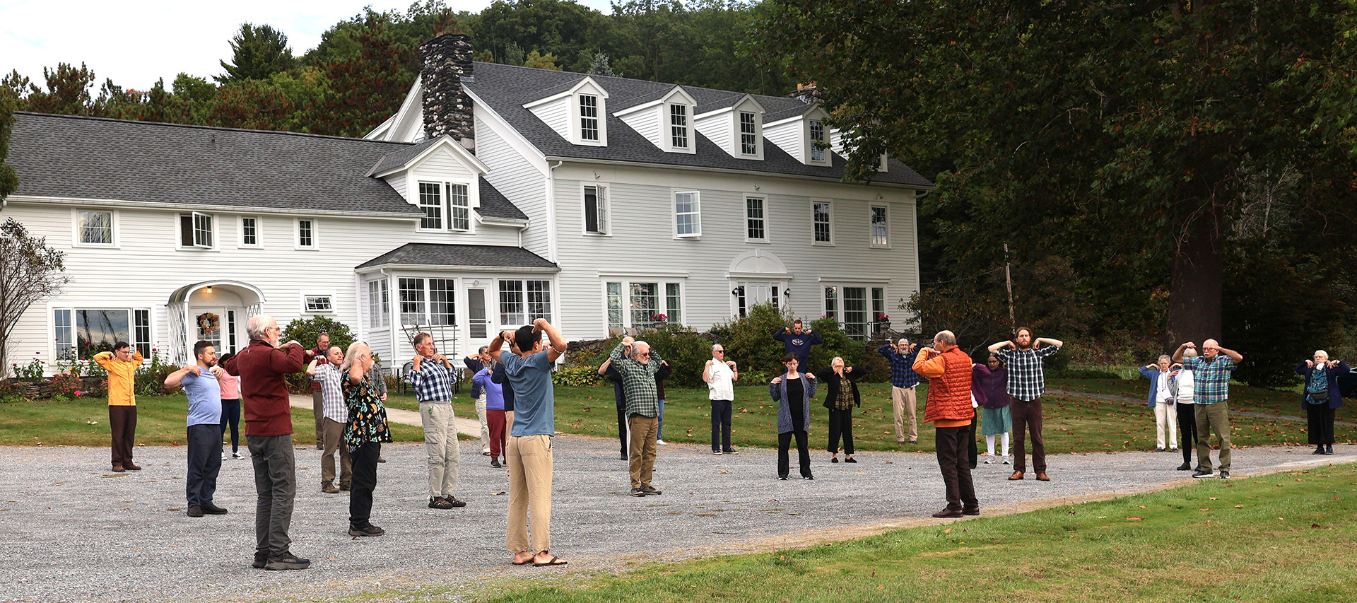 Brother Keshavananda conducts the practice of the Energization Exercises before a group meditation.