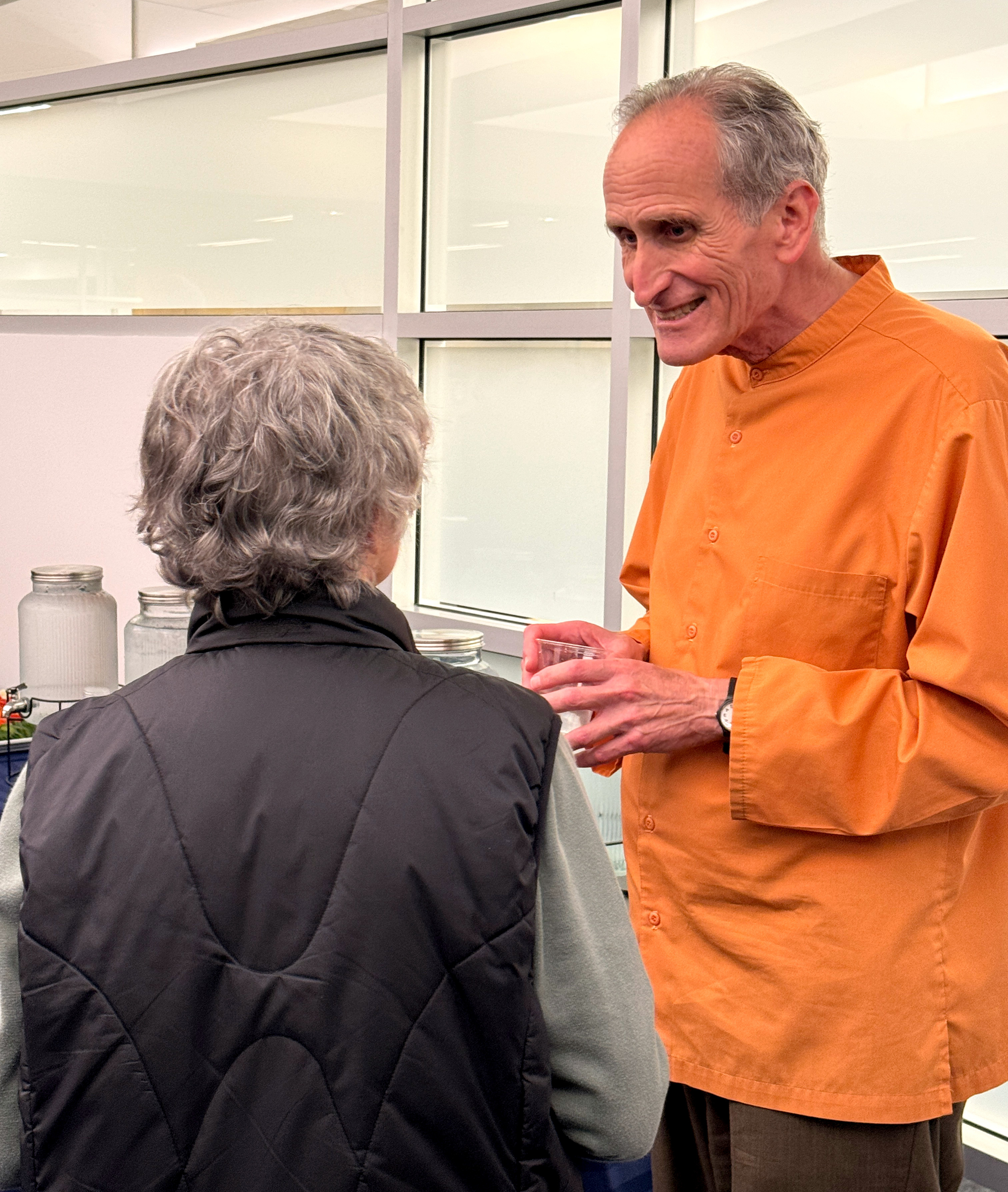 Brother Bhumananda greets a Vancouver participant.