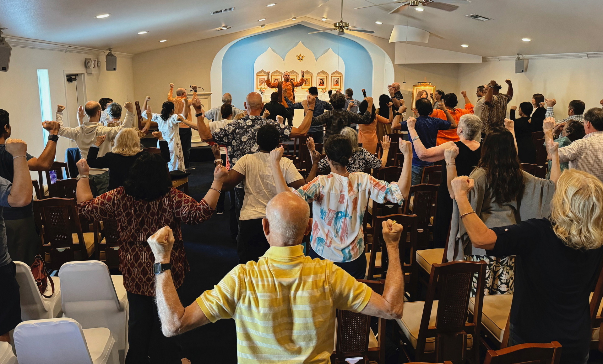 Brother Vidurananda conducts a review of the Energization Exercises for Houston members.