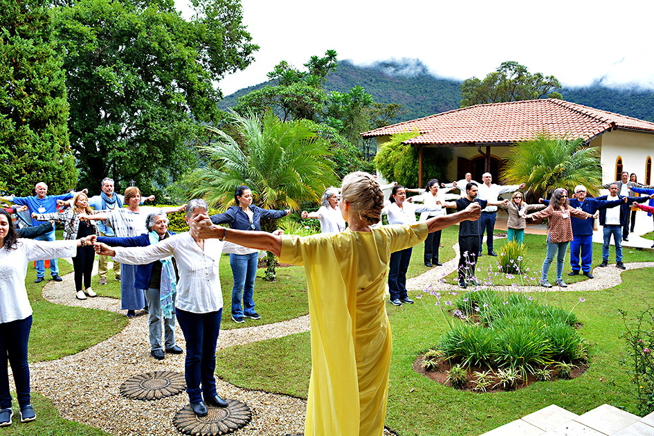 Brahmacharini Sophie conducts a practice of the Energization Exercises before a group meditation.