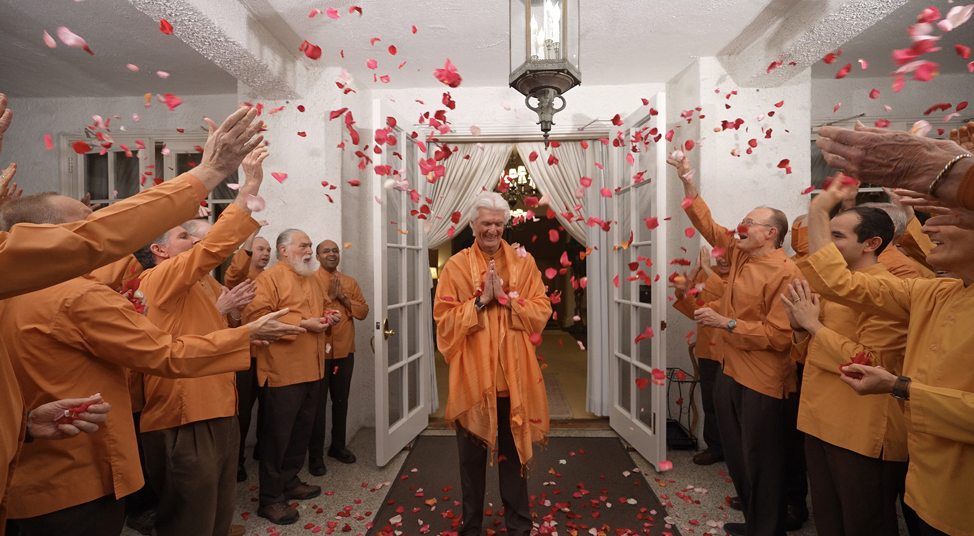 SRF monks shower Brother Chidananda with rose petals as he departs from the Mother Center.