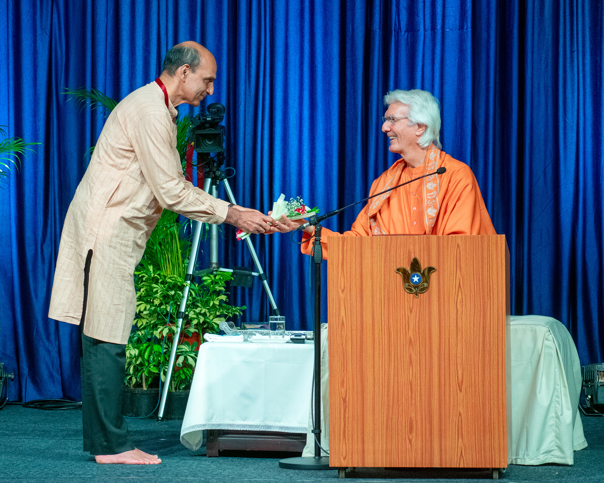Brother Chidananda is offered flowers as a token of love and gratitude of behalf of all the devotees.